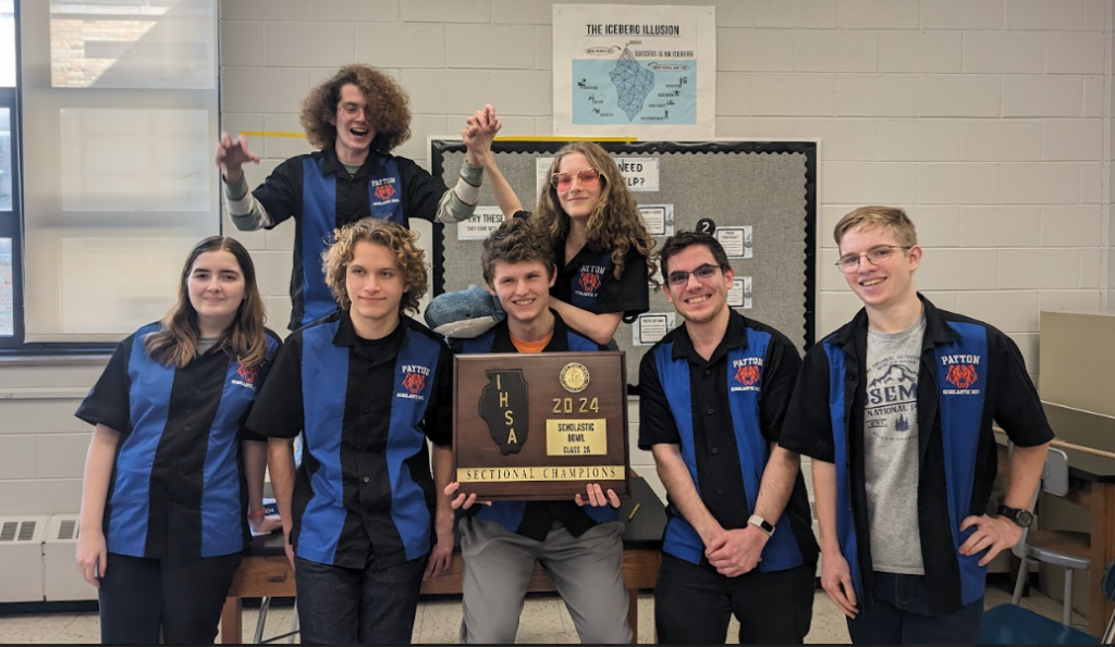 Walter Payton's team posing with their IHSA Scholastic Bowl sectional champions plaque.